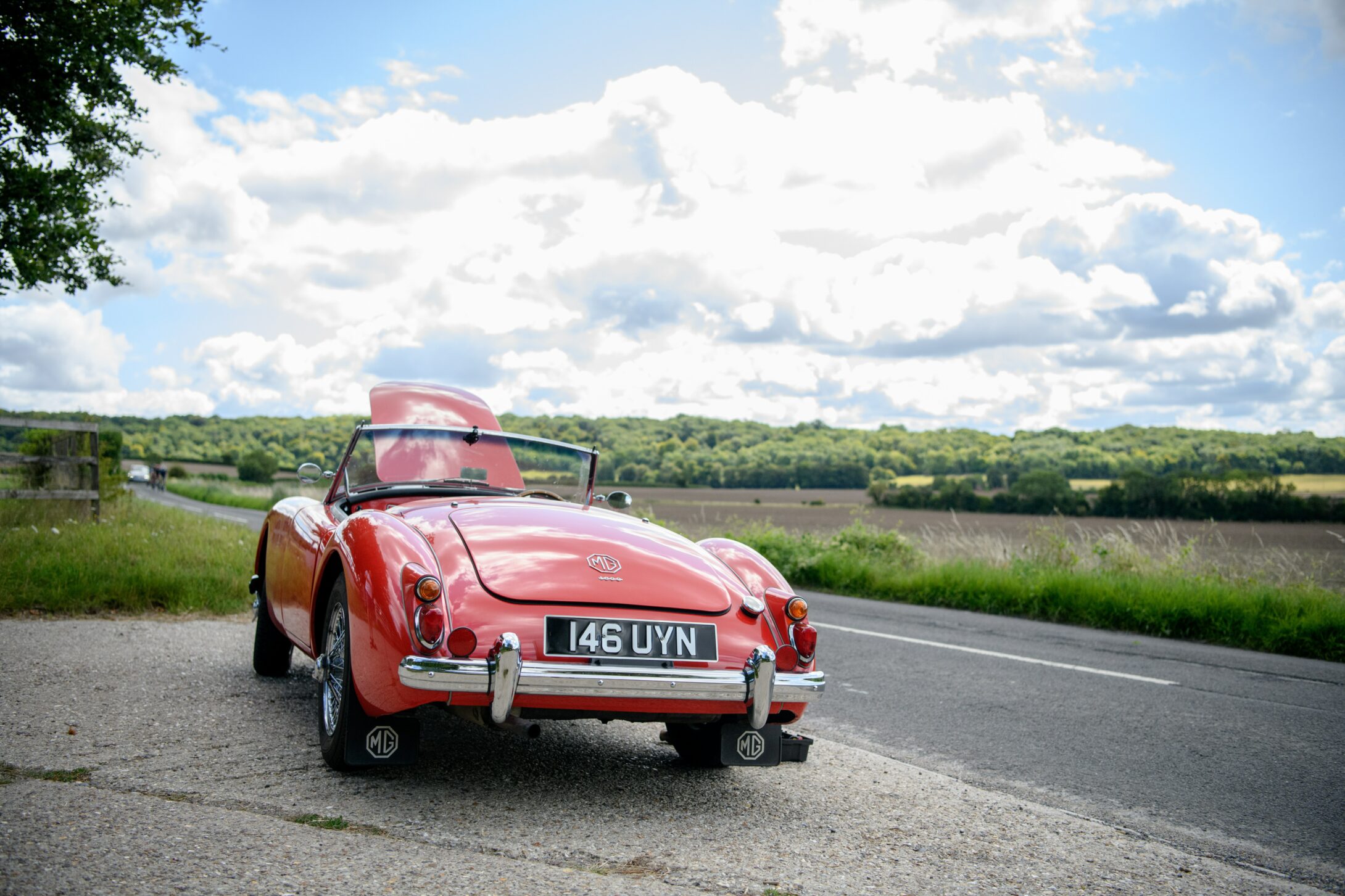 A broken car standing on a road indicating breakdown