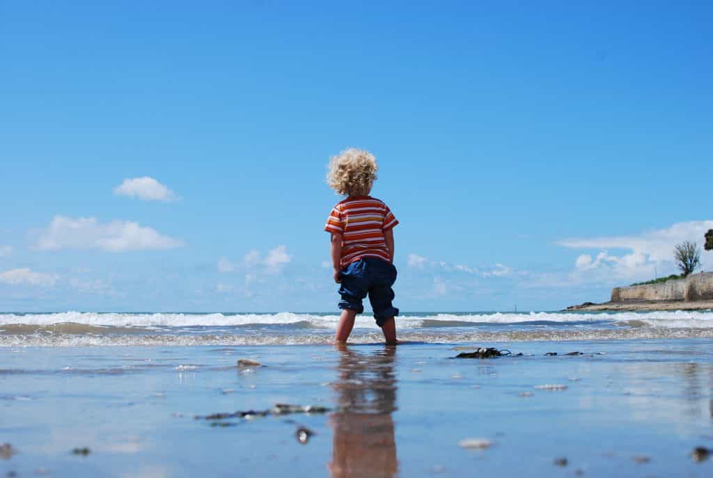 A child standing on a beach