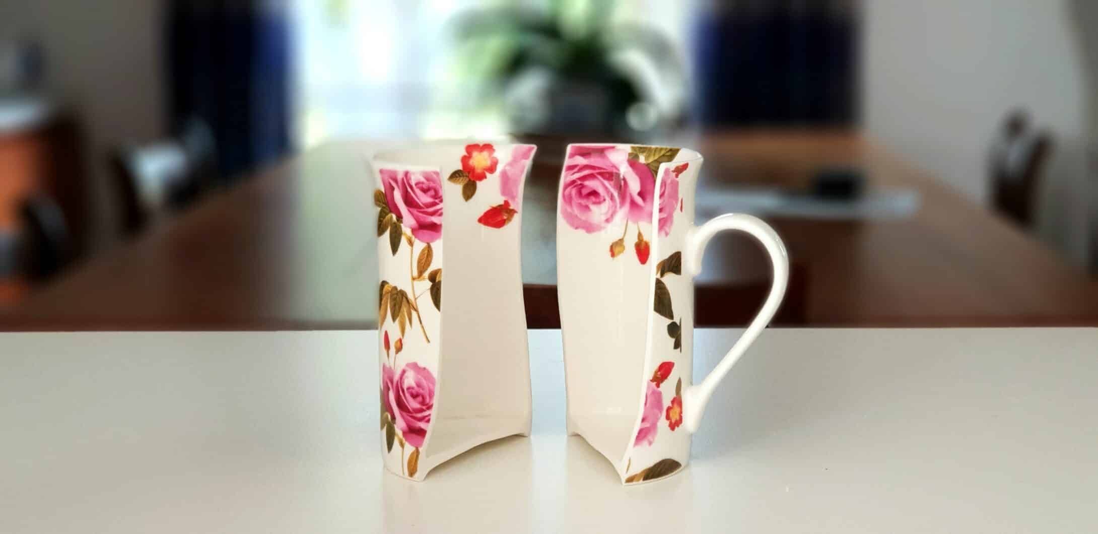 Two pieces of a broken cup standing on a table