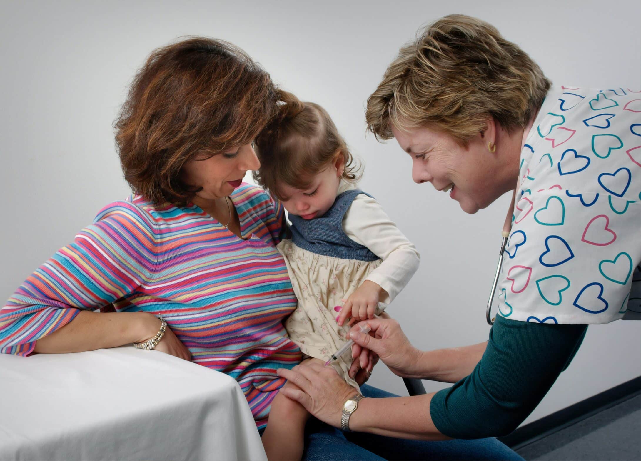 A doctor is vaccinating a child