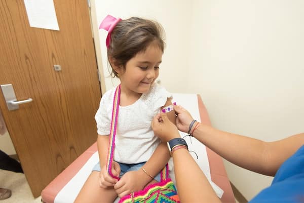 Doctor is vaccinating a child with covid-19 vaccine
