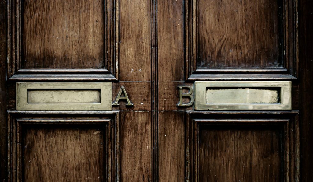 A and B written on a wooden door indicating a comparision