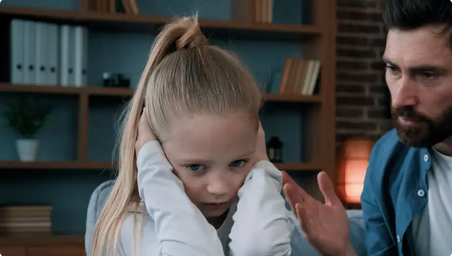 Little girl hearing father denigrate mother