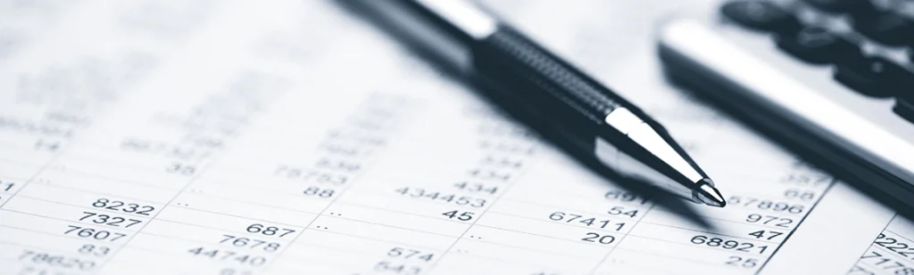 financial statement and balance sheeet on desk of financial advisor