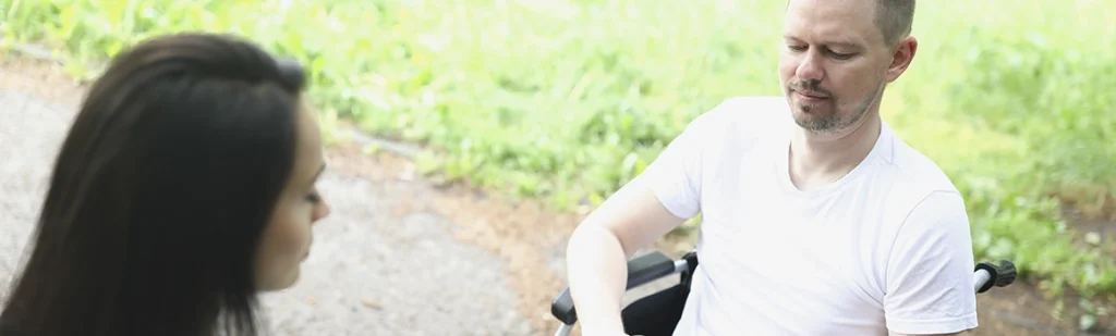 Disabled man in wheelchair talking with ex wife