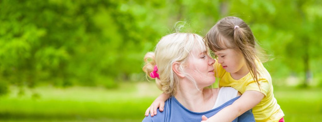Mom with special needs child playing outdoor