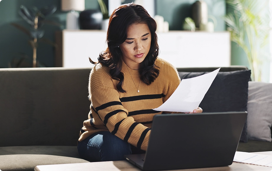 Spouse reviewing financial statements with a worried expression