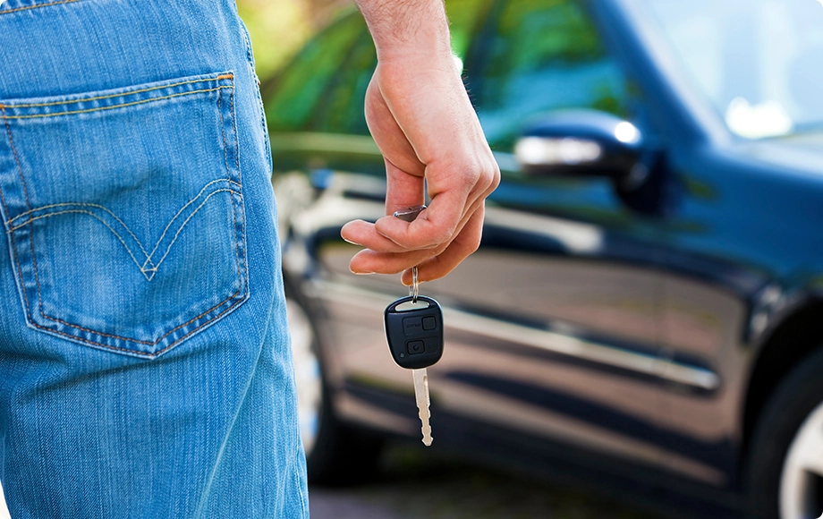 close up of man holding keys thinking can my spouse take my vehicle.