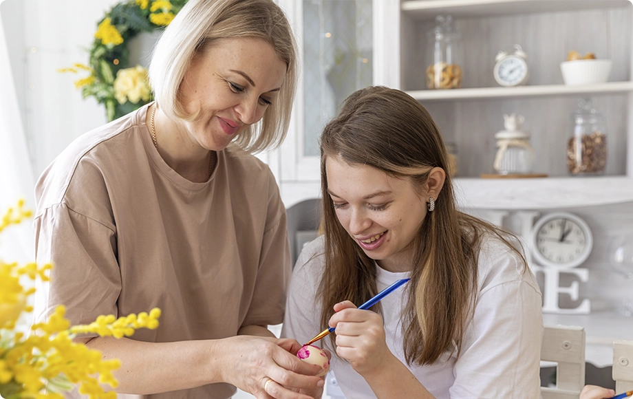 Mom with special needs child painting