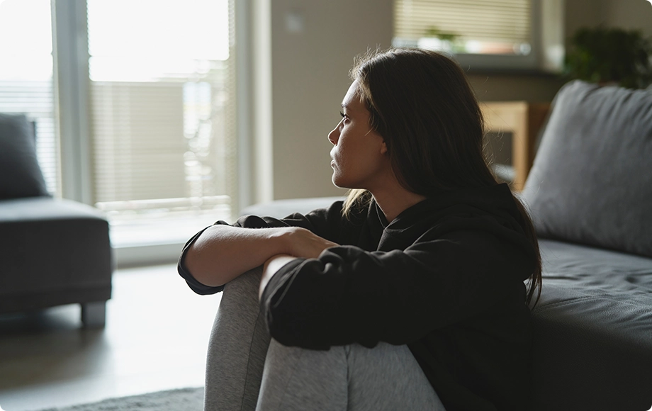 A woman looking at the window, thinking about divorcing her narcissist husband