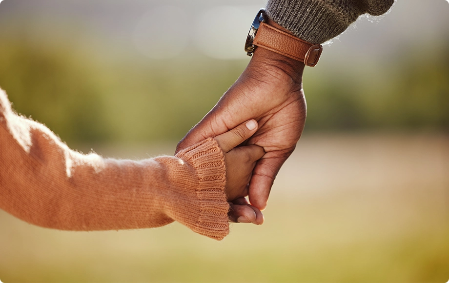 Gay parent holding his child´s hand celebrating custody granted