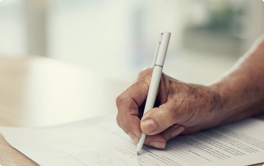 Elderly woman signing a divorce petition