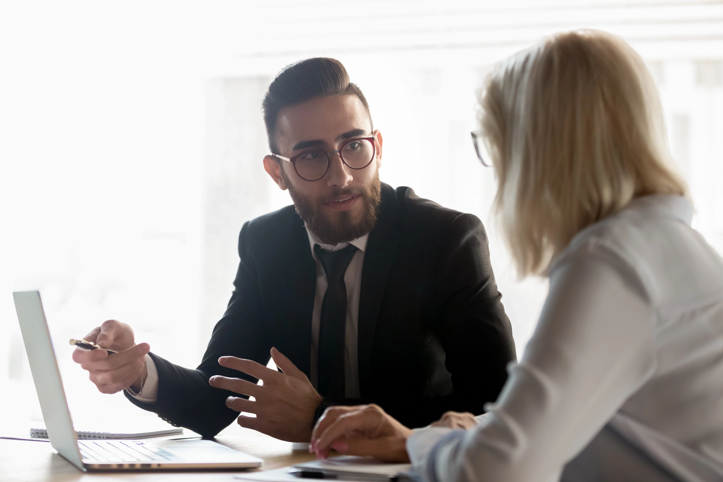 Collaborative divorce meeting with attorneys and spouses at a table in Seattle, WA
